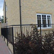 Side of persimmon house with black handrail